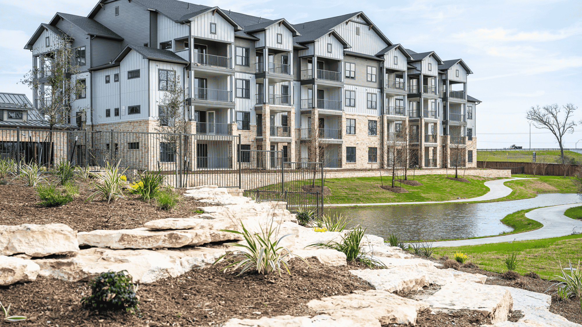A senior couple riding bicycles on a path through a park