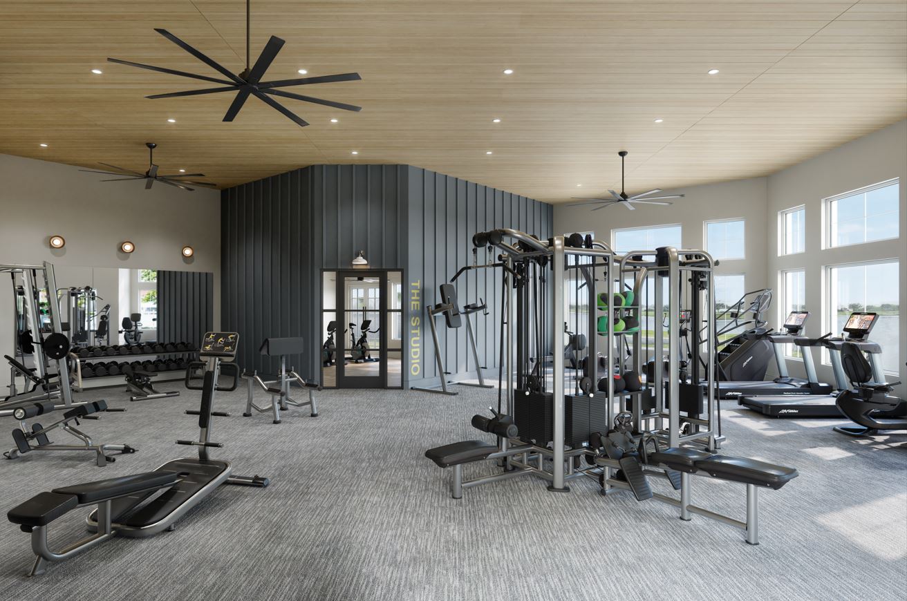 Modern gym with various exercise equipment.