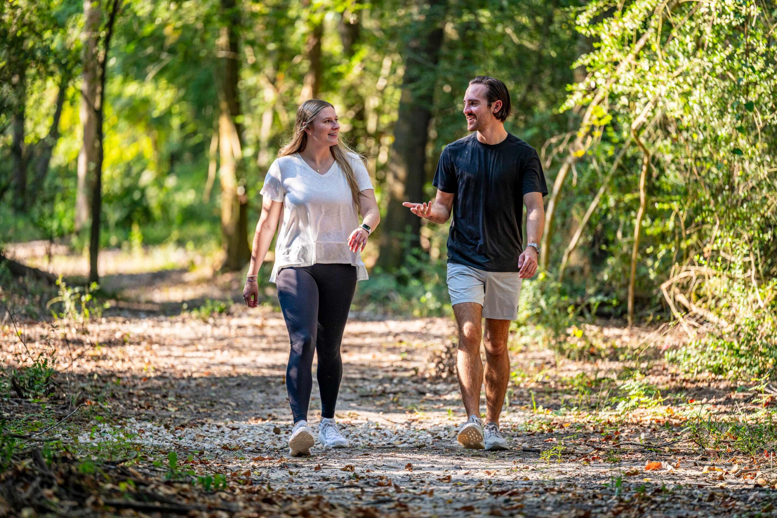 Friends walking and talking on a nature trail