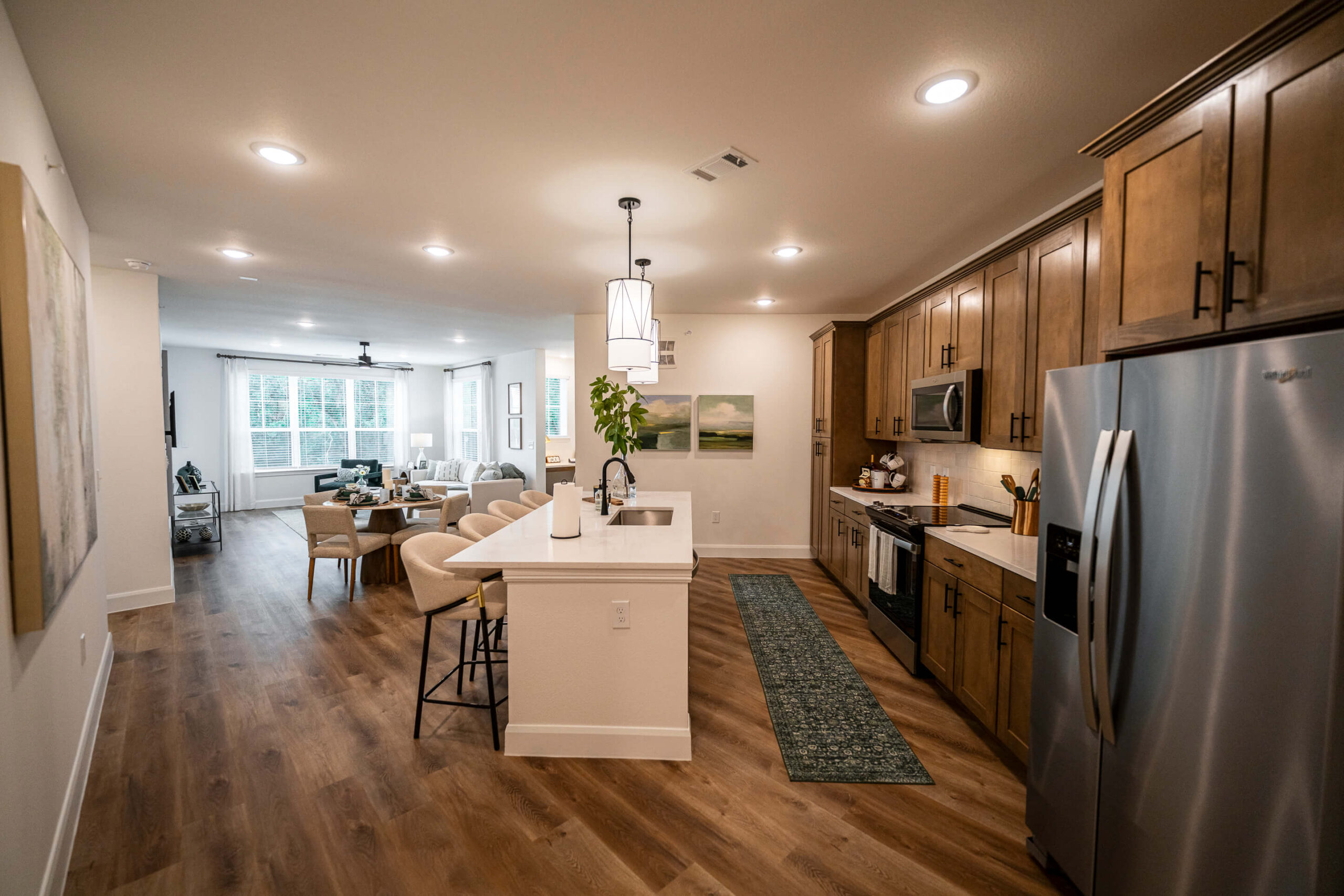 Kitchen and living area with barstools at the island